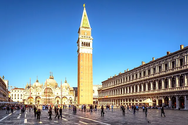 Piazza San Marco in warm evening light, with the Campanile, the Basilica and the arcades of the Procuratie
