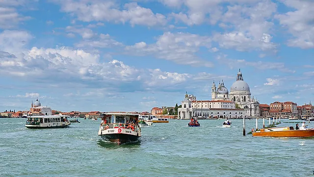 Vaporetto water buses crossing the Bacino di San Marco, with the domes of Santa Maria della Salute on the horizon